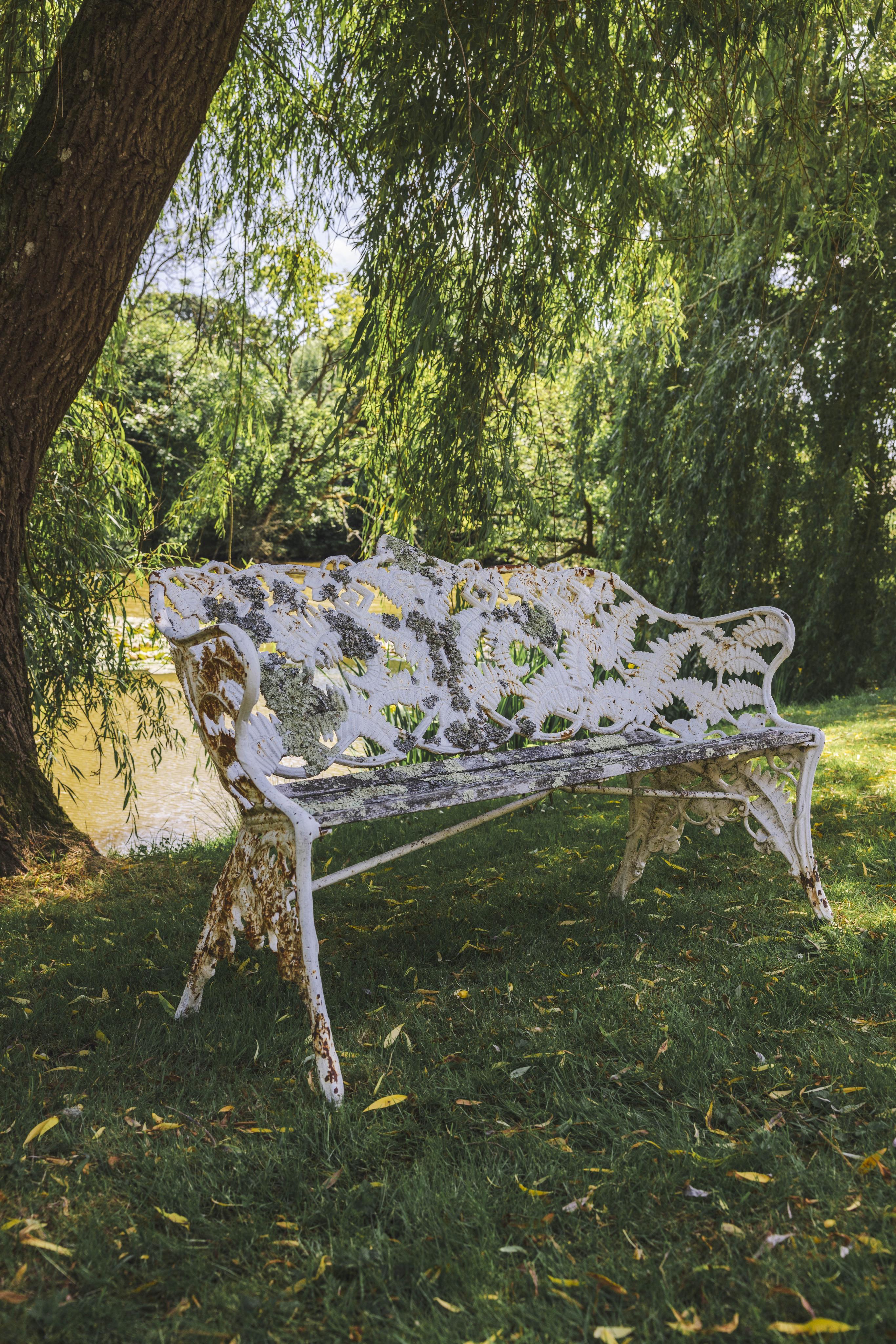A Victorian Coalbrookdale style fern pattern white painted cast iron garden bench, width 152cm, depth 56cm, height 91cm